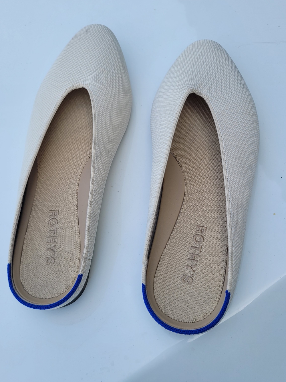 Rothy's Cream Pointed Toe Flats with Blue Heel Accent